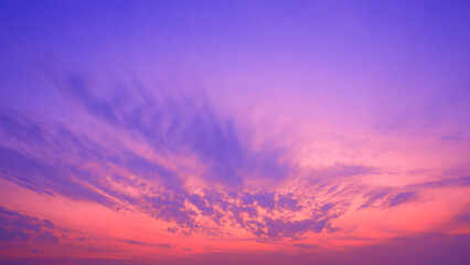 Sunset sky background with orange sunlight and cloudy on blue twilight sky after sundown - obrazy, fototapety, plakaty