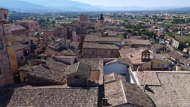 Aerial view of the church Santa Maria Maggiore in Spello, a charming town in Umbria, province of Perugia, dolly move forward
