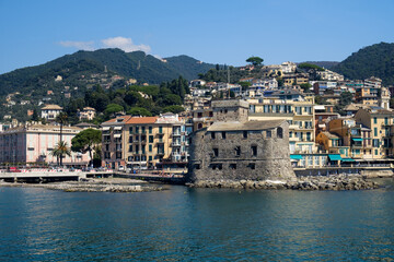 Naklejka premium The castle and the hilly coastline with buildings in Rapallo, Liguria, Italy.