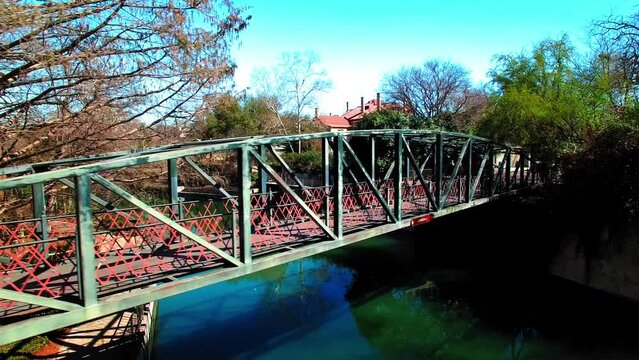 Panning Shot Of Famous Bridge Over River In City Against Clear Sky - San Antonio, Texas
