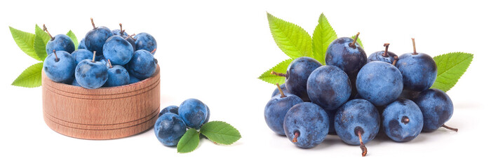 blackthorn berries with leaves in a wooden bowl isolated on white background
