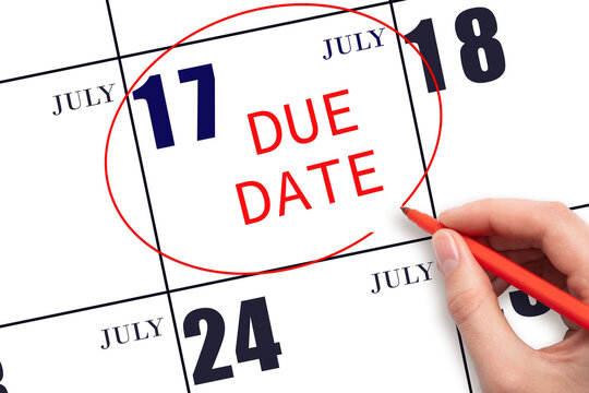 Hand Writing Text DUE DATE On Calendar Date July 17 And Circling It. Payment Due Date