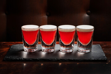 shots with vodka on wooden background