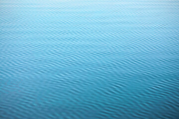 Turquise sea texture - wave pattern, gentle wind ripples the surface of the water. Parallel and diagonal lines.