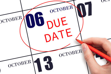 Hand writing text DUE DATE on calendar date October 6 and circling it. Payment due date