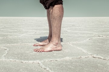 Man standing bare foot in the Salt Flats of Utah