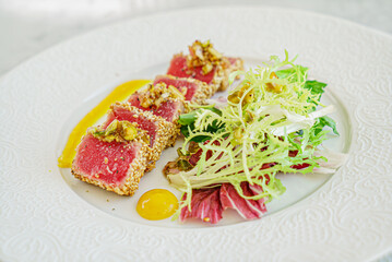 sliced tuna steak with sesame and vegetables