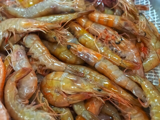 Raw fresh shrimps in a pile at a seafood market
