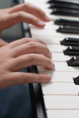 Music exercises. Piano two hands playing lessons. Keyboard close-up