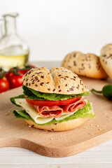 Sandwich with ham, cheese, salad and tomato for breakfast