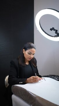 Woman of Latin ethnicity in an aesthetic store of eyebrows and nails. Preparing the eyebrows on the table