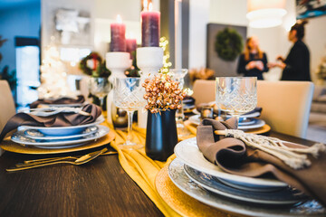 Christmas Eve table decorations, Christmas mood, Christmas tree on the dining table. Defocused