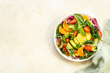 Healthy vegetarian bowl - green salad with avocado and tomatoes