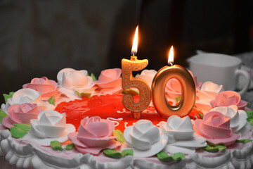 Birthday cake 50th anniversary, golden candle on a beautiful cake decorated with flowers, roses....