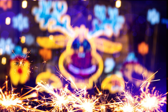 Bokeh effect of Christmas decorations and light garlands.Abstract blurred christmas background with sparkler