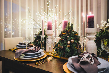 Christmas Eve table decorations, Christmas mood, Christmas tree on the dining table. Defocused
