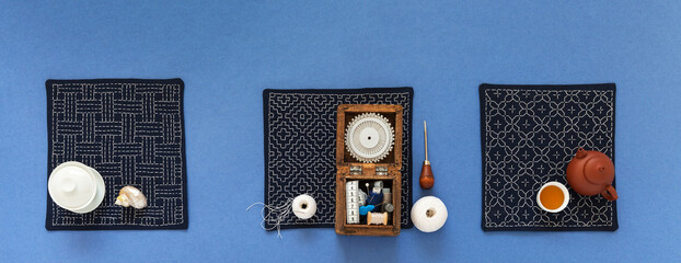 Three handmade napkins embroidered with Sashiko style geometric pattern. Box with sewing...