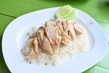 steamed rice topped with chicken.Rice topped with boiled chicken oup, and spicy sauce,thai food,chicken rice service,Fried Chicken with Rice.