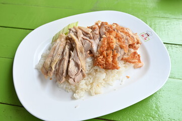 steamed rice topped with chicken.Rice topped with boiled chicken oup, and spicy sauce,thai food,chicken rice service,Fried Chicken with Rice.