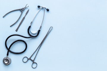 Dental or surgical steel instruments with stethoscope. Healthcare background