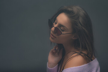 Portrait of a girl posing in studio while beign around steam