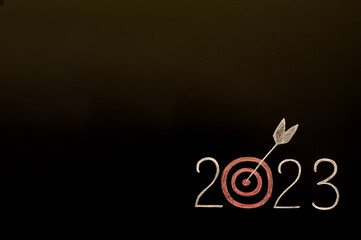 Blackboard with chalk-written number of the new year 2023.  Resolutions, plan and goals, checklist concept. New Year 2023 background template, copy space.