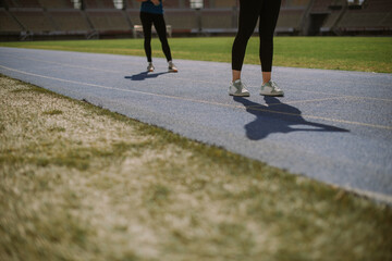 Fototapeta premium Sporty girls standing on a sports track