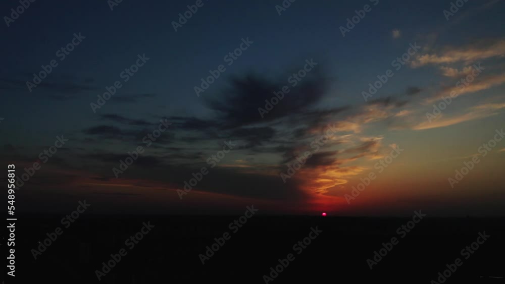 Wall mural Drone flying over the clouds at sunset