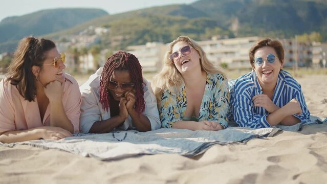 Cinematic storytelling footage of beautiful plus size women having fun at the beach in the summertime. Oversized big girls friends, representation of body positivity and body acceptance concepts