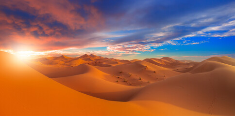 Beautiful sand dunes in the Sahara desert with amazing sunrise sky - Sahara, Morocco