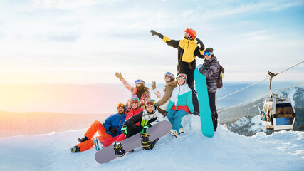 Team winter sports skiers and snowboarders with sun light. Concept travel ski resort with group of friends - obrazy, fototapety, plakaty