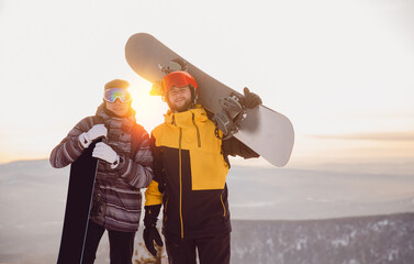 Team winter sports skiers and snowboarders with sun light. Concept travel ski resort with group of...