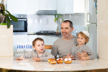 Father and sons with menorah celebrate hanukkah - Jewish religious holiday