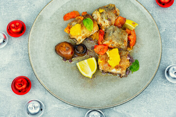 Fish hake prepared with mushrooms and oranges.