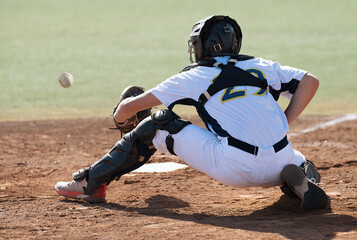 Baseball catcher during game, baseball catcher reaching to catch ball