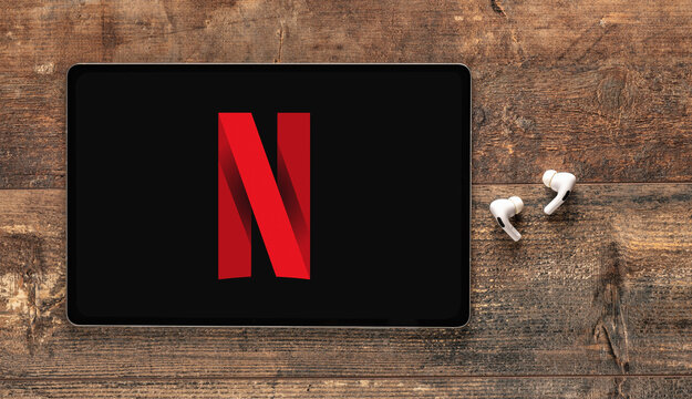 New York, USA - November 25, 2022: Netflix logo on Apple Ipad and earphones. Netflix is global provider of streaming movies and TV series.
