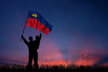 Father and son hold the flag of Liechtenstein