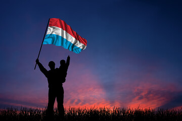 Father and son hold the flag of Luxembourg