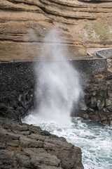 tall gush of ocean water on volcanic cliffs at Porto de Cruz, Madeira