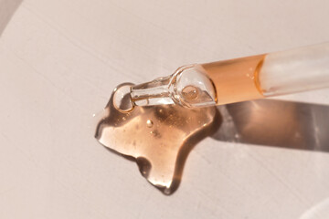 Pipette with fluid serum, oil, face gel cleaner. Cosmetics and healthcare concept closeup. Dose of...