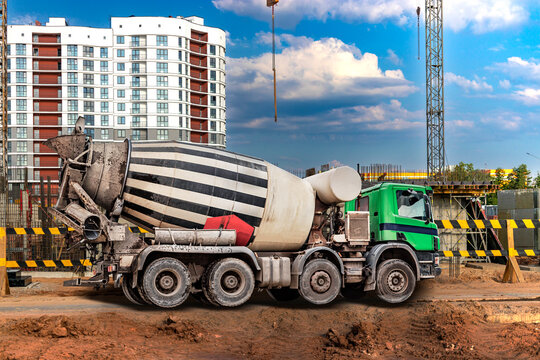 Concrete mixer truck at the construction site. Delivery of concrete for pouring foundations and building structures.