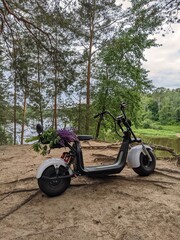 motorcycle on the picturesque background of a wide river in summer