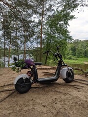motorcycle on the picturesque background of a wide river in summer