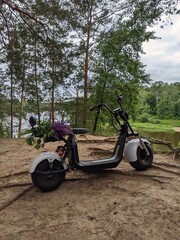 motorcycle on the picturesque background of a wide river in summer