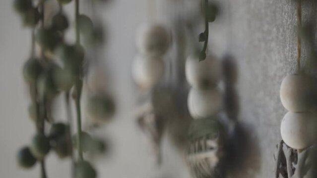 Shot of a kind of wall decoration with amulet elements made of stone and wood