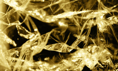 Gold foil background with light reflections. Golden textured wall.