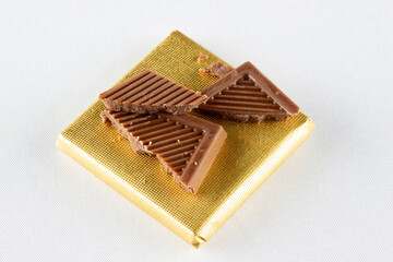 Cracked milk chocolate bars. Food background.