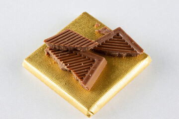 Cracked milk chocolate bars. Food background.
