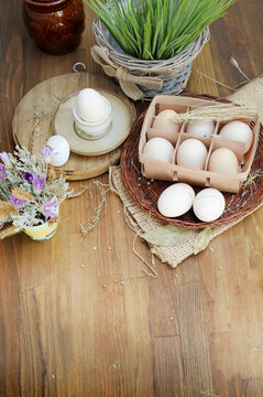 Organic raw chicken eggs in egg box on an old style wooden background