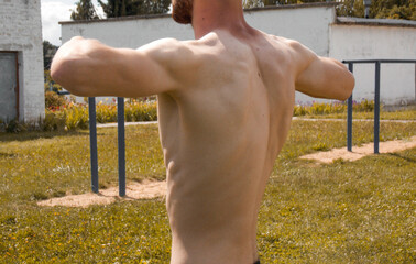 Warm-up before training. The pumped-up guy is warming up. Close-up